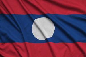 Laos flag  is depicted on a sports cloth fabric with many folds. Sport team banner photo