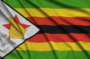 Zimbabwe flag  is depicted on a sports cloth fabric with many folds. Sport team banner photo