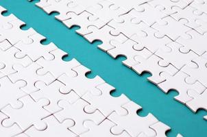 The blue path is laid on the platform of a white folded jigsaw puzzle. Texture image with copy space for text photo