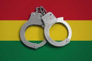 Bolivia flag  and police handcuffs. The concept of observance of the law in the country and protection from crime photo