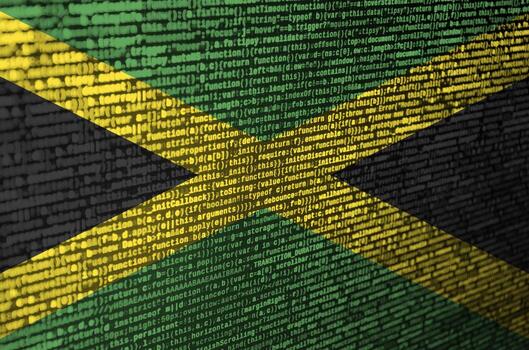 Jamaica flag  is depicted on the screen with the program code. The concept of modern technology and site development photo