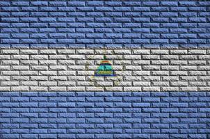 Nicaragua flag is painted onto an old brick wall photo