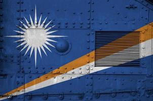 Marshall Islands flag depicted on side part of military armored tank closeup. Army forces conceptual background photo