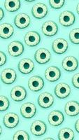 Many small plastic donuts lies on a pastel colorful background. Flat lay minimal pattern. Top view photo
