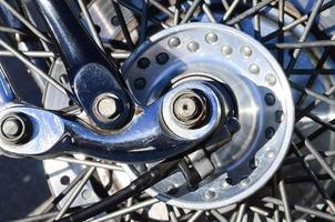 Fragment of chromed shiny wheel of old classic motorbike photo