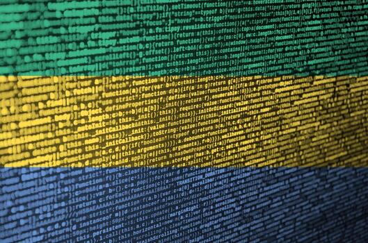Gabon flag  is depicted on the screen with the program code. The concept of modern technology and site development photo