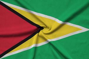 Guyana flag  is depicted on a sports cloth fabric with many folds. Sport team banner photo