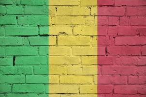 Mali flag is painted onto an old brick wall photo