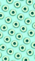 Many small plastic donuts lies on a pastel colorful background. Flat lay minimal pattern. Top view photo