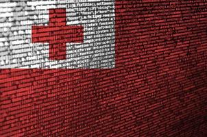 Tonga flag  is depicted on the screen with the program code. The concept of modern technology and site development photo