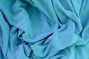 The texture of the fabric in blue color. Material for making shirts and blouses photo