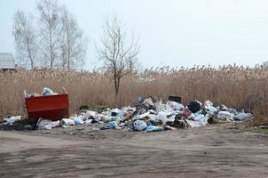 Garbage can is packed with garbage and waste. Untimely removal of garbage in populated areas photo
