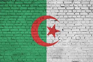 Algeria flag is painted onto an old brick wall photo