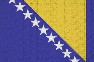 Bosnia and Herzegovina flag  is depicted on a folded puzzle photo