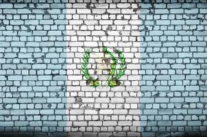 Guatemala flag is painted onto an old brick wall photo