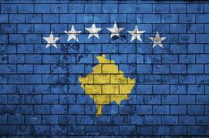 Kosovo flag is painted onto an old brick wall photo