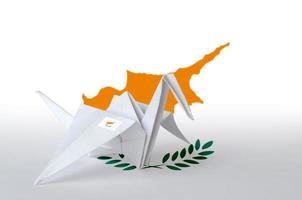 Cyprus flag depicted on paper origami crane wing. Handmade arts concept photo