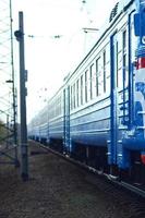 Old soviet electric train with outdated design moving by rail photo