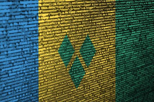 Saint Vincent and the Grenadines flag  is depicted on the screen with the program code. The concept of modern technology and site development photo