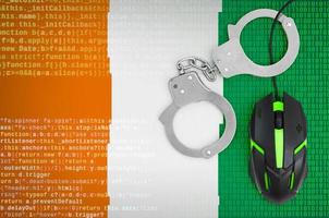 Ivory Coast flag  and handcuffed computer mouse. Combating computer crime, hackers and piracy photo