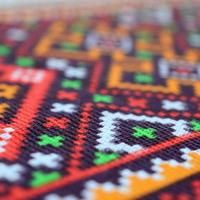 Traditional Ukrainian folk art knitted embroidery pattern on textile fabric photo