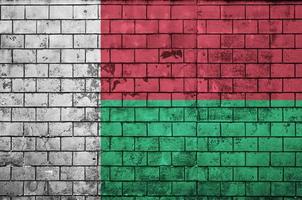 Madagascar flag is painted onto an old brick wall photo
