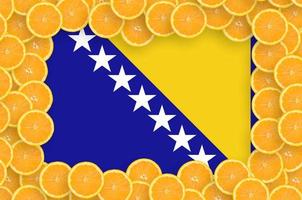 Bosnia and Herzegovina flag  in fresh citrus fruit slices frame photo