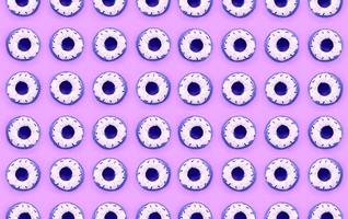Many small plastic donuts lies on a pastel colorful background. Flat lay minimal pattern. Top view photo