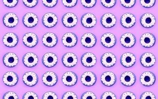 Many small plastic donuts lies on a pastel colorful background. Flat lay minimal pattern. Top view photo