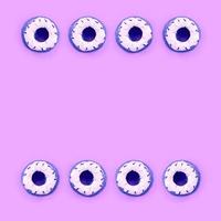 Many small plastic donuts lies on a pastel colorful background. Flat lay minimal pattern. Top view photo