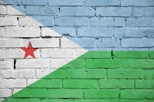 Djibouti flag is painted onto an old brick wall photo