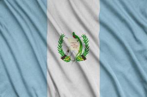 Guatemala flag  is depicted on a sports cloth fabric with many folds. Sport team banner photo