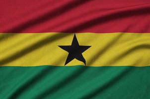 la bandera de ghana está representada en una tela deportiva con muchos pliegues. bandera del equipo deportivo foto