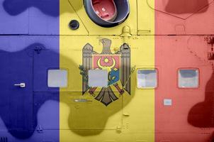 Moldova flag depicted on side part of military armored helicopter closeup. Army forces aircraft conceptual background photo