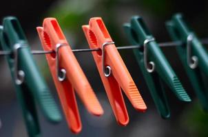 Clothespins on a rope hanging outside house and apple tree photo