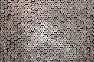 Pattern of 12 gauge cartridges for shotgun bullets. Shells for hunting rifle close up. Backdrop for shooting range or ammunition trade concepts photo