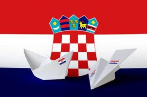 Croatia flag depicted on paper origami airplane and boat. Handmade arts concept photo
