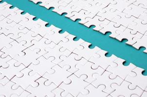 The blue path is laid on the platform of a white folded jigsaw puzzle. Texture image with copy space for text photo