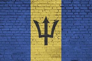 Barbados flag is painted onto an old brick wall photo