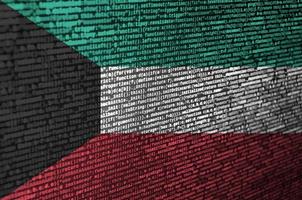 Kuwait flag  is depicted on the screen with the program code. The concept of modern technology and site development photo