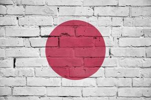 Japan flag is painted onto an old brick wall photo