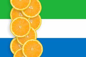 Sierra Leone flag and citrus fruit slices vertical row photo