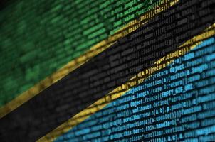Tanzania flag  is depicted on the screen with the program code. The concept of modern technology and site development photo