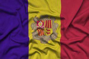 Andorra flag  is depicted on a sports cloth fabric with many folds. Sport team banner photo