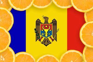 Moldova flag  in fresh citrus fruit slices frame photo