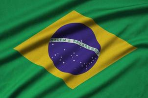 Brazil flag  is depicted on a sports cloth fabric with many folds. Sport team banner photo