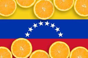 Venezuela flag  in citrus fruit slices horizontal frame photo