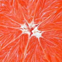 Top view of a fragment of the grapefruit slice close up. Macro background texture photo