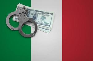 Italy flag  with handcuffs and a bundle of dollars. The concept of breaking the law and thieves crimes photo