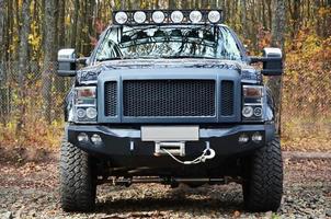 Off-road car on the background of autumn trees photo